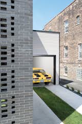 This Brick Weave House in Chicago includes a garage that allows the homeowners to have easy access to work on their vehicles, designed by Studio Gang Architects.