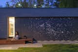 Architect Janna Levitt laser-cut an astral pattern into the garage door of this renovated Toronto home, installing LED lights behind the fiber-cement surface to complete her depiction of the constellations Sagittarius and Scorpio. 