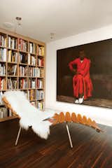 #interior #modern #inside #design #interiordesign #seatingdesign #seating #loungechair #fur #wallart #bookcase #shelving #bookwall #ceilinglight #woodfloor #library #palmslounger #lynetteyiadomboakye #painting #fransschrofer 