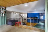 #shippingcontainer #modern #steel #color #interior #indonesia #greenroof #naturallight #openplan #openfloorplan #lowcost #concrete #polishedconcrete #recycledmaterials #railings #bookshelf #seating #sofa #coffeetable #blue #stairs #woodceiling #woodfloor 