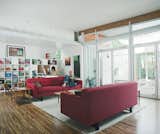 #shippingcontainer #modern #interior #livingroom #bookcase #exterior #lighting #openplan #sofa #redcouch #roomandboard #coffeetable #endtables #storefrontdoor 