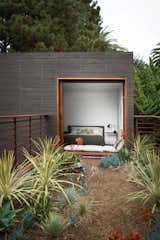 A guest bedroom, with furniture from Room & Board, overlooks the bridge above the dining courtyard. The home’s landscape architecture is by Ventura, California–based Jack Kiesel. Photo by Coral von Zumwalt.