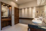The spacious bathroom features wood paneling and Hansgrohe fixtures. The sink and toilet are from Villeroy & Boch.
