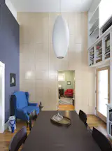 Schmeil says of spaces, like the dining room/library shown here, "Although the house feels like it has distinct spaces and zones, it feels bigger than its actual size, thanks to the visual connection between rooms and the numerous windows which allow for a changing quality of light throughout the day." Photo by Whit Preston.