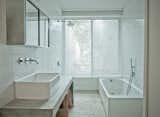 The master bath is a clean and spare space, a mixture of white and concrete.