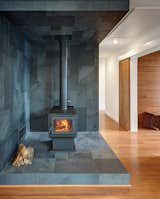 Vermont slate covers the area around the True North wood stove.  Wide-plank Yanachi Carbonized Strand Woven Bamboo covers the floors.  Photo 3 of 6 in How to Build an Off-the-Grid Cabin in Arkansas for just over $118,000