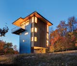 Rough-sawn plywood and standing-seam metal siding clad the house. "In cabins, we like to use undressed materials, which lend themselves to the simplicity of the structure," says architect Tom Lenchek.