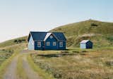 Montrealers Yves Bériault and Diane Decoste worked with the Montreal firm YH2 to update their 1,690-square-foot vacation home in Havre-Aux-Maisons, in Canada's Magdalen Islands, into a modern retreat. The renovation work revealed that the house, first built in 1915 as a one-room schoolhouse, had a spectacular arched open space hidden above a false ceiling. Photo by Matthew Monteith.  Photo 12 of 13 in What a Fresh Coat of Paint Can Do by Luke Hopping from Modern Farmhouses