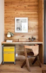 A yellow Pedestal filing cabinet by USM is tucked under a built-in desk in the guest bedroom. The leather-back chair was designed by Michael Robbins, a furniture designer based in New York's Hudson Valley.