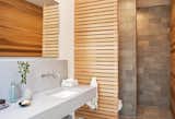 The master bathroom features a cedar screen and quartzite tiles by Walker Zanger.