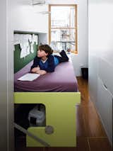 In this tightly spaced apartment in New York, noroof Architects designed a multifunctional piece of furniture for the kid's room. All it takes is a little gentle pressure to lower the desk to the floor, bringing the kid-size mattress into position for bedtime.  Photo 8 of 10 in The Art of the Statement Piece by Eujin Rhee from A Storage-Smart Renovation in New York City
