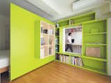 Shibata wanted more shelf space in her home office, so she added a plywood door with built-in bookshelves that opens into her bedroom to form a reading nook. Glimpsed from the adjacent room, the space looks larger than it actually is, thanks to the bright green walls.