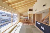 The 13-foot-wide sliding window provides abundant natural light year-round. The staircase was placed at the building's center to maximize openness and make space for the carport below. The blackboard is for the couple's young son, Takuma, to play with and practice writing.