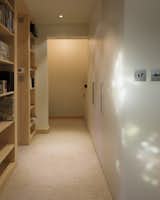 The flat is approximately 195-square-feet, forcing a level of economy in the design. This hallway leads to the entrance, as well as provides access to a storage room and bathroom.