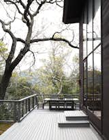 An L-shaped deck wraps around the house's ground level, creating a place for entertaining and taking in the scenery.