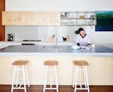 Kitchen, Range, Concrete, White, Wood, Open, and Dark Hardwood In the kitchen, Dedo stools by Simone Simonelli for Miniforms pull underneath a poured-in-place concrete countertop.  Kitchen Dark Hardwood Open Photos from Skype Lets a Family Renovate Their Kitchen 3,700 Miles Away