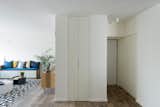 The clients were expecting their second child and it was important that there was as much space as storage. Studio Bazelet found a clever solution by building a slender closet behind the living room wall and custom furniture with storage.