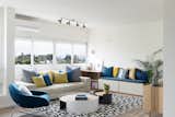 One of the custom pieces the firm designed is a bench with storage in the living room made from African wood.