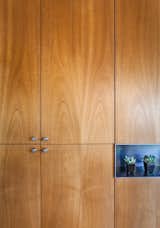 At a renovated home in Nevada, cabinetmaker Ben Wilborn carefully matched the grain of the kitchen cabinets, and the homeowners paired the wood with modern stainless steel cabinet pulls.