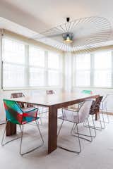 In the Tribeca penthouse of a young bachelor, Reddymade Design kept most of the space intact, focusing on adding bright and appealing furniture and materials. Tropicalia chairs from Moroso surround an El Dom table from Cassina. The pendant is from Petite Friture.