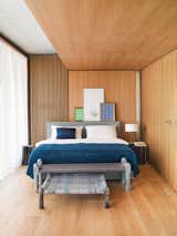 The cozy bedroom is clad in oiled oak.