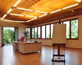 A movable desk, sliding storage system for large canvases, and plenty of open space meet the artist's request for functionality. The sloped ceiling is made of Douglas fir.