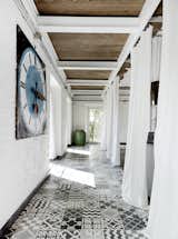 Hallway and Ceramic Tile Floor A carpet of custom tile created by Navone punctuates a corridor on the first floor.  Photo 3 of 7 in Modern Renovations of Period Homes by Jacqueline Leahy from Paola Navone's Industrial Style Renovation in Italy