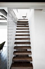 Staircase, Wood Tread, and Metal Railing The upper level of the 5,300-square-foot space is accessed via a slender stair with reclaimed-wood treads.  Photos from Paola Navone's Industrial Style Renovation in Italy