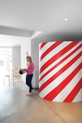 Daughter Oona stands near the candy-striped wardrobe in the entryway.