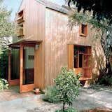 Outside, the couple clad the house with a rain screen of 1.5-by-1.5-inch strips of spruce to create a “modern rustic barn.” The extra-deep sills of the first-floor window become a bench on the outside and a shelf on the inside.