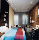 "I think of the bed as intimate space, and putting the bed away—having it out of sight when not in use—is satisfying," says Milan Hughston, who reconfigured his West Village apartment with the help of architect Joel Sanders. This custom-designed Murphy bed, concealed by day behind the gold curtain, is well built; it's ergonomically easy to lower and has a firm sleeping surface.