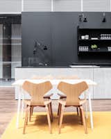 The yellow area features a cafe with wooden Vitra chairs around tables by .TEBIAN.