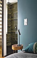 A sliding door divides the verde bamboo granite bathroom from the bedroom.