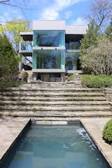 The home's newly renovated rear facade, which contains the kitchen and dining room, were aligned along the same axis as the backyard pool to create unified, linear sightlines across the property.  Search “Coolest-Homes-for-Artists--Art-Collectors.html” from Inspired by an Art Piece, a Collector Renovates His Toronto Home