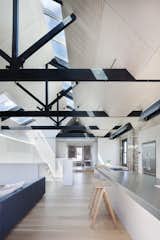 “The fact that the external walls were built to the site’s boundary led to the solution of skylights as the one of the few means of introducing north light and good cross ventilation into the building,” Simpson continues. The hanging lights are from Artemide while the hotplates and cooktops are from Barazza.