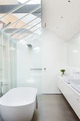 “A critical aspect of the project was the incorporation of natural light and ventilation within a broad footprint,” Simpson says. Conventionally private areas, like bedrooms and bathrooms, are therefore reinterpreted with more openness in mind. For instance, this bathroom’s skylights mirror those found throughout the rest of the property. The bathtub, basins, and showerhead were all purchased at the Australian retailer Reece.