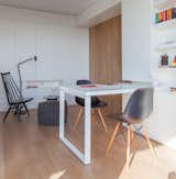 This bright apartment renovation in Barcelona by Architectural design firm YLAB Arquitectos Barcelona, yielded a discrete home work space that's divided from from the living room with a sliding door.  Photo 7 of 11 in 10 Essential Tips for Creating a Hardworking Home Office from A Light, Bright Apartment Renovation in Barcelona