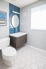 The renovated bathroom features tiles from Heath Ceramics.