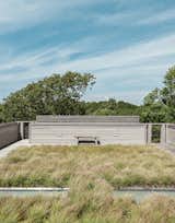 Landscape architects Reed Hilderbrand helped fill out the completed prefab by planting sedge grass on one of the house’s two green roofs to reflect the texture of the surrounding meadow.
