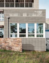 Exterior, House Building Type, Beach House Building Type, Wood Siding Material, and Stone Siding Material The two-foot-thick stacked stone walls constructed by Reed Hilderbrand nod to the masonry-free walls common in Revolutionary-era New England.  Photo 5 of 56 in Prefab by Kristian Morton from An Unconventional Prefab on Fishers Island