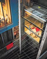 The couple’s daughters, Fiona and Olivia, try out the central elevator, which is shared by all the owners and tenants and was designed, says Lang, “to encourage neighbor interaction.”  Photo 4 of 7 in A Modern Multiunit Prefab Prototype in Vancouver