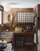 In one house, a small kitchen features a cupboard with sliding shoji screens.