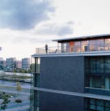Cox enjoys the view from his penthouse terrace. The steel used for the terrace, and the brick-colored cladding of the building, echo the industrial architecture of the area. The angles suggest a ship, a nautical link with Duisburg’s past as a major port.