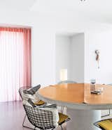 Dining Room, Chair, and Table A pair of interior architects with a years-in-the-making furniture collection recast an old Belgian factory as a playful family home.  Photo 7 of 41 in 50 Dashing Dining Rooms from Design Classic: Bertoia Seating Collection