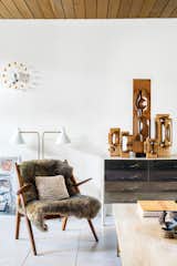 Mark Neely and Paul Kefalides’s living room is decked out with the couple’s vintage finds, including a Hans Wegner Sawback chair (the fur throw obscures an area needing repair), a George Nelson Ball Clock, a DF-2000 cabinet by Raymond Loewy, a light designed by Greta Von Nessen, and a suite of Brian Willshire wooden sculptures, one of Neely’s many collections.