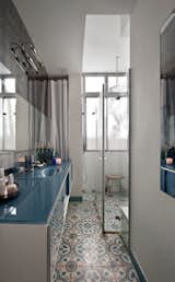 In the bathroom, Reik hand-made the tiles and also the blue glass cabinet that holds the sink.