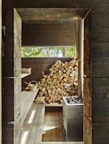 A wood-burning stove from Harvia, of Finland, heats the sauna. The pavilion’s rough-cut pine walls are treated with tar, a preservative that yields a time-worn aesthetic.