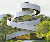 Hiroshi Nakamura's Ribbon Chapel in Hiroshima orients two asymmetrical winding pathways that connect at a rooftop apex.  Photo 11 of 12 in Architect-Designed Chapels Create Modern-Day Places of Worship by Kelsey Keith