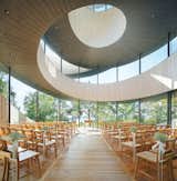 The curling "ribbons," intersected by glass cathedral walls, rise to a central oculus for a sublime effect.  Search “Domestic-Ribbon.html” from Architect-Designed Chapels Create Modern-Day Places of Worship