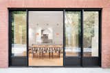 The owners requested that an enlarged passageway connect the dining room to a new outdoor space on the home’s south facade, which Moreau and his team achieved with a 15-foot opening and French doors. A clay brick veneer replaces the existing brick exterior.